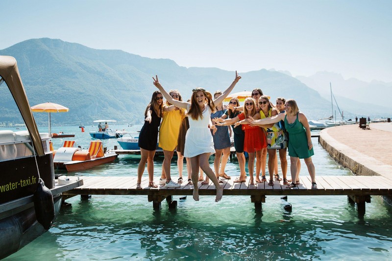 Future mariée qui saute d'un ponton avec ses demoiselles d'honneur