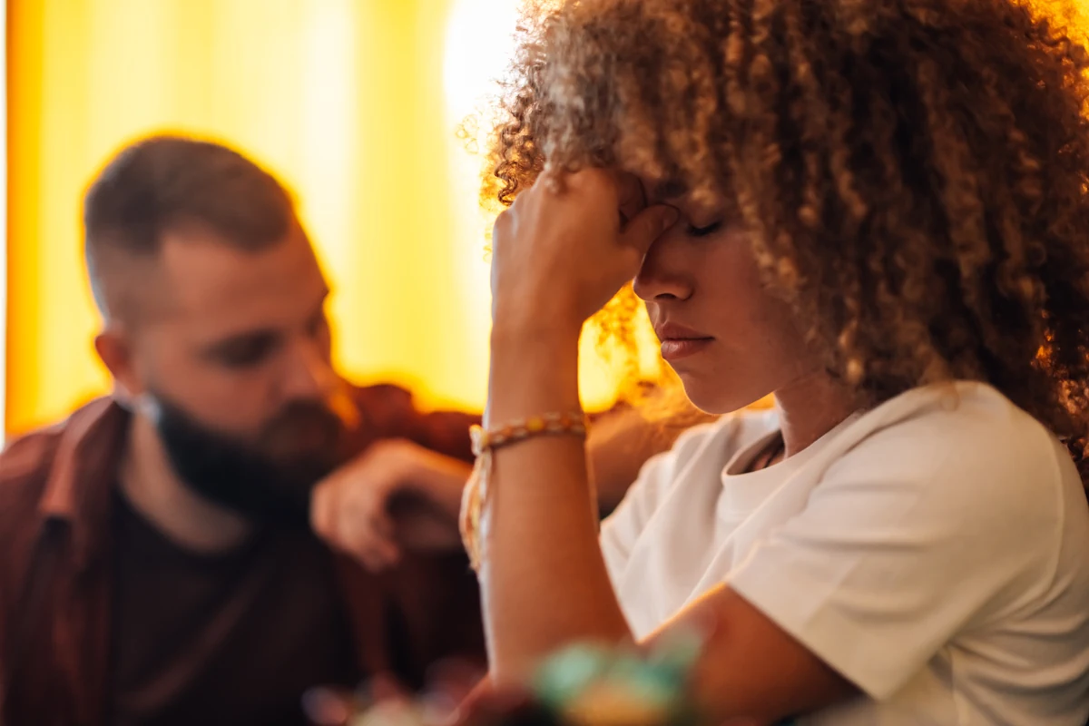 Une femme qui baisse les yeux près d'un homme